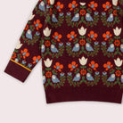 Maroon sweater with colorful bird and floral pattern on a white background