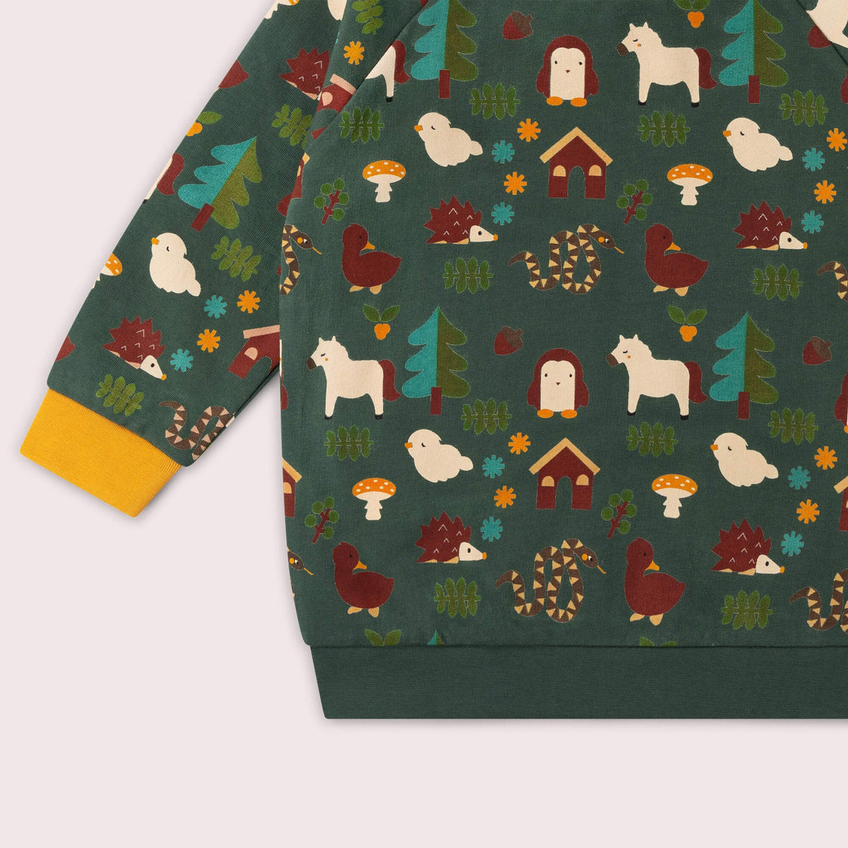 Children's sweatshirt with a forest-themed pattern featuring animals and nature elements on a green background.