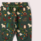 A pants with a forest-themed print on a dark green background, featuring woodland motifs like trees, mushrooms, houses, and animals matching green drawstring.