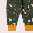 A pants with a forest-themed print on a dark green background, featuring woodland motifs like trees, mushrooms, houses, and animals.