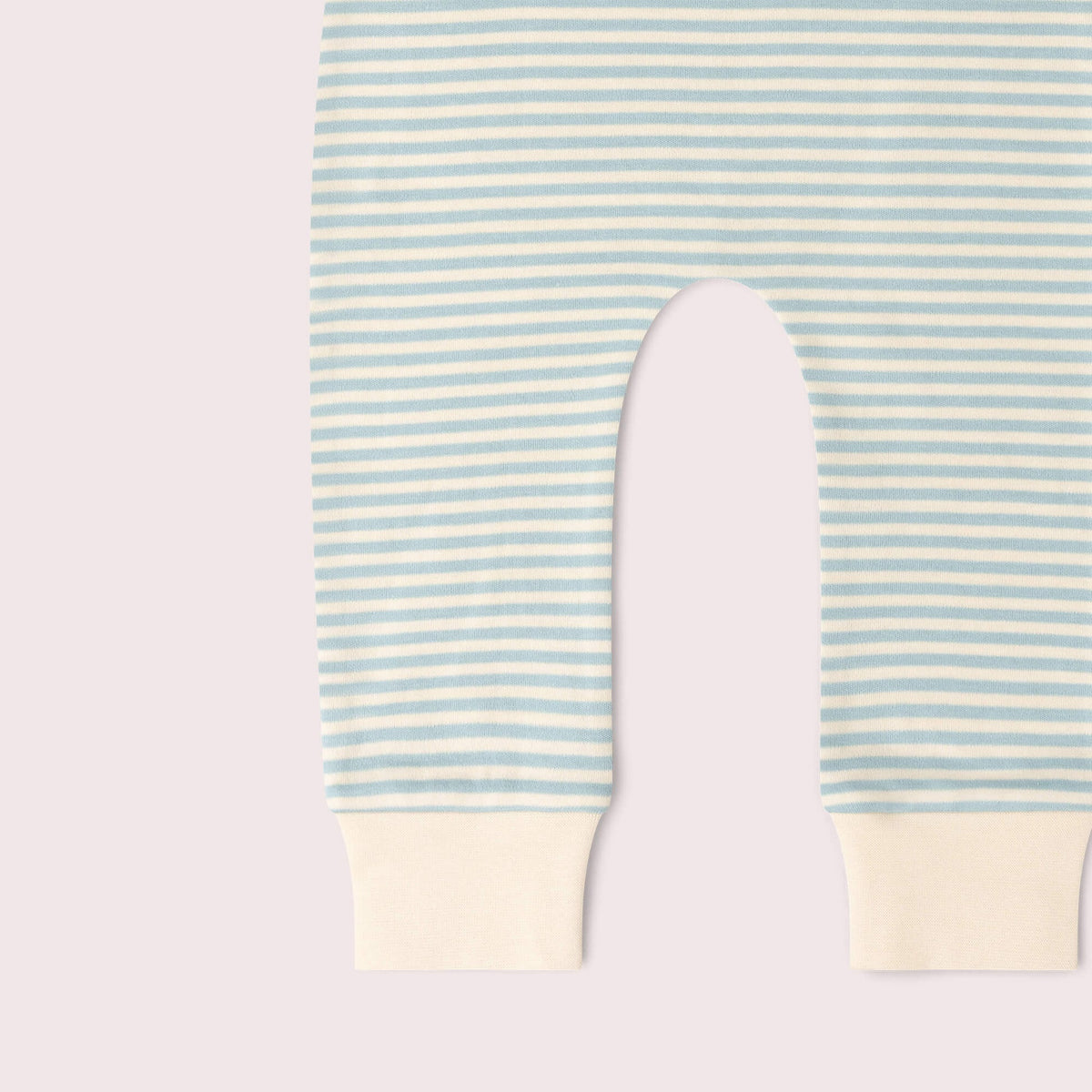 Close-up of a baby garment with horizontal mint green and white stripes, featuring solid cream ribbed cuffs at the bottom.