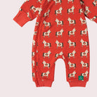 A baby hooded one-piece romper in red with an all-over dog print, featuring a striped hood lining and a front zipper, shown on a plain white background.