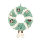 A plush donut-shaped hanging decoration in mint green and white faux fur, with embroidered facial features, small brown acorn appliqués, and tan nut illustrations, shown on a plain white background.
