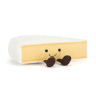 Plush toy resembling a banana with a smiling face on a white background