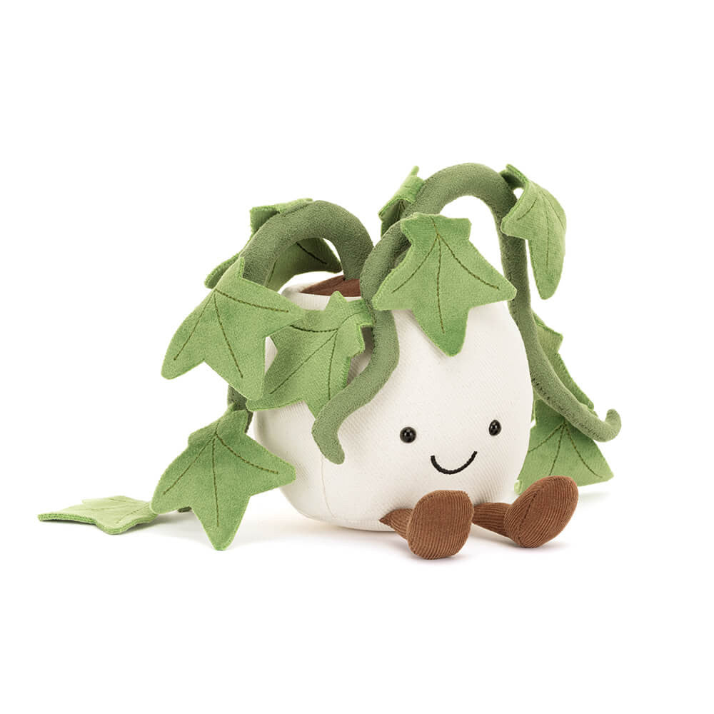 A cute, soft plush toy shaped like a smiling white bean pod with green leafy vines growing out of it, set against a plain white background.