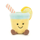 A plush toy resembling a glass of lemonade with a lemon slice and a straw, smiling face at the bottom.