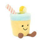 A plush toy resembling a glass of lemonade with a lemon slice and a straw, smiling face at the bottom.