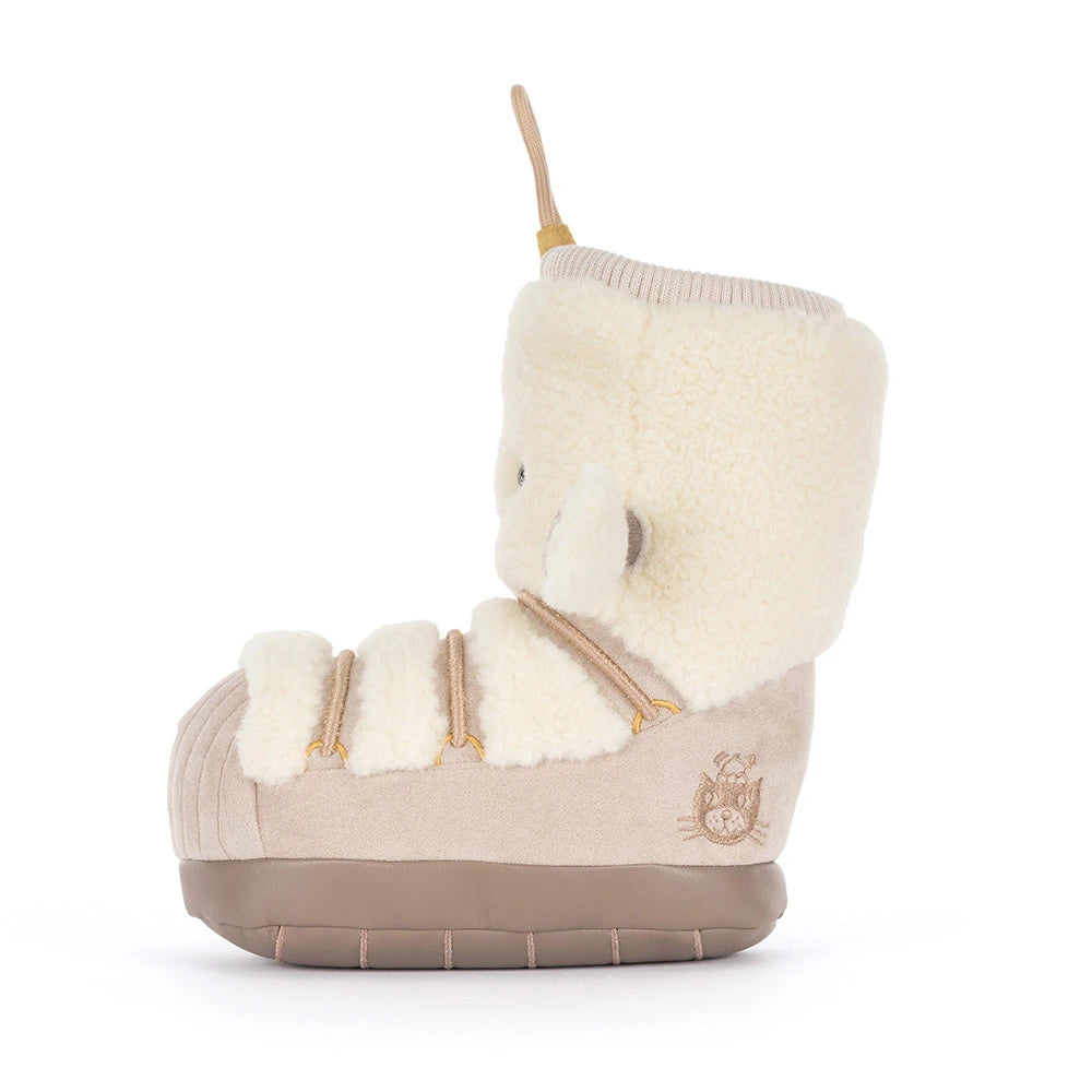 A single mid-calf boot with a cream-colored plush fleece collar and trim, a beige suede-like body, and a brown sole, shown from a side profile on a white background.