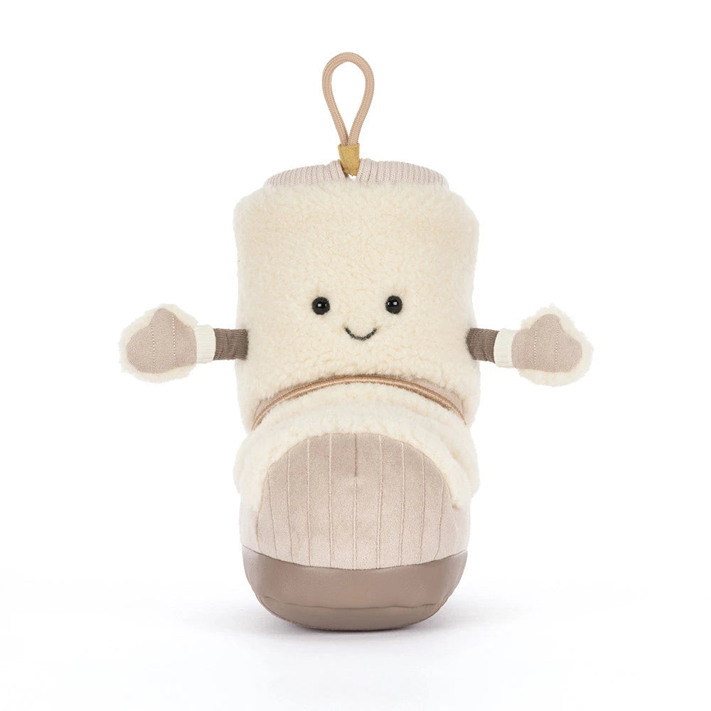 A plush bootie-shaped character toy in cream and beige, with a smiling face, small arms, and a hanging loop at the top, photographed on a clean white background.
