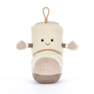A plush bootie-shaped character toy in cream and beige, with a smiling face, small arms, and a hanging loop at the top, photographed on a clean white background.