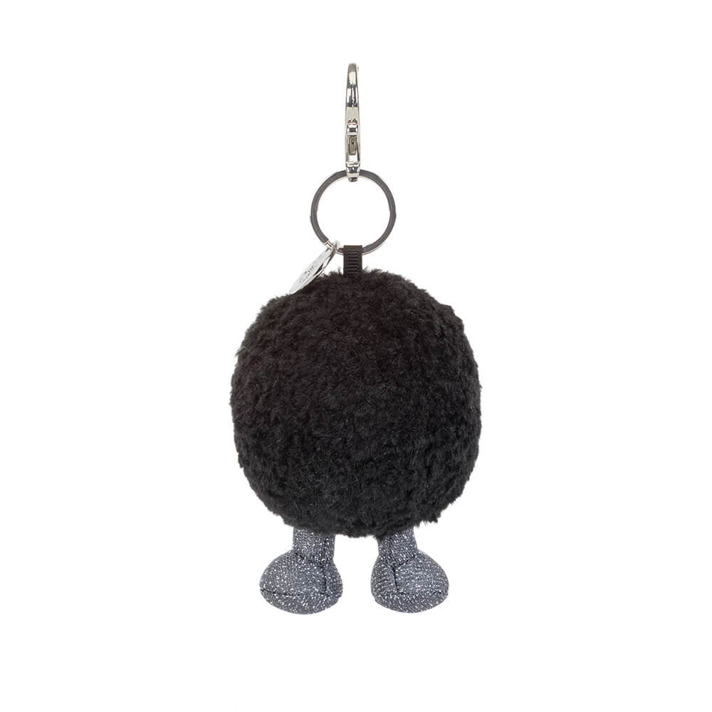 Black fuzzy keychain with legs on a white background