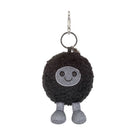 Black plush keychain with a smiling face on a white background
