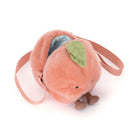 Plush peach-shaped bag with a green leaf on a white background