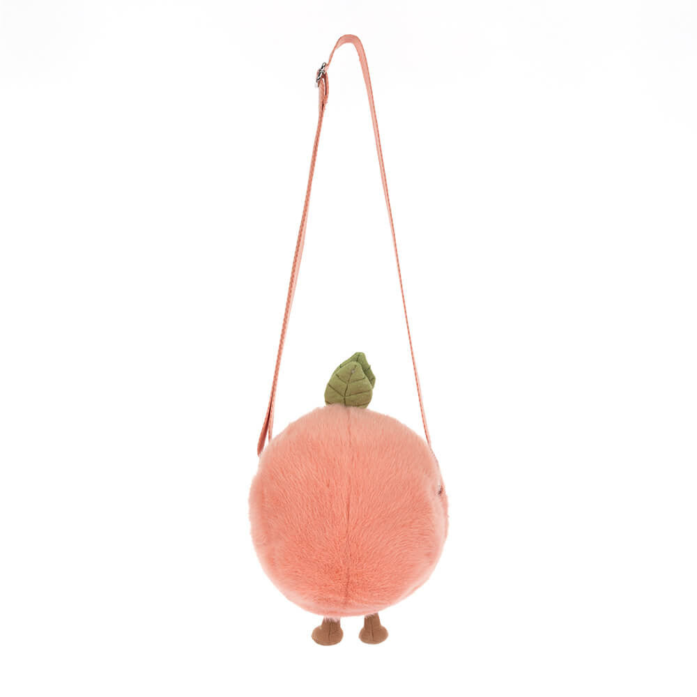 Plush peach-shaped bag with a strap on a white background