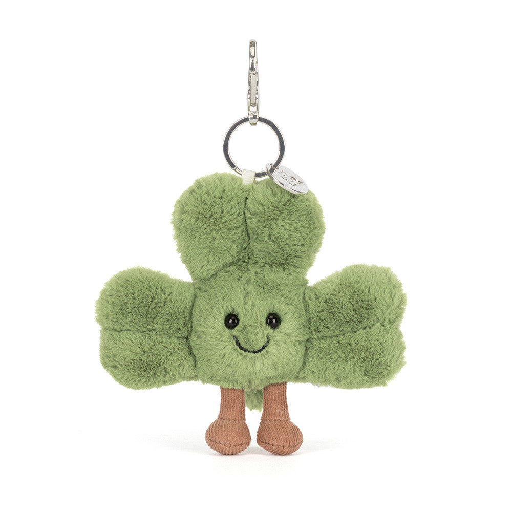 Green plush keychain with a smiling face on a white background