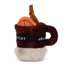 A plush novelty mug toy featuring a dark burgundy fuzzy handle, a black band with white text reading 'JELLYCAT' and 'MYCAT', a light beige base, and a small orange plush basketball with a brown cinnamon stick on top, photographed on a white background.
