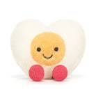 Round plush toy with a smiling face, beige body, and pink legs on a white background