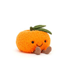 Plush toy resembling a cartoonish orange with a smiley face on a white background