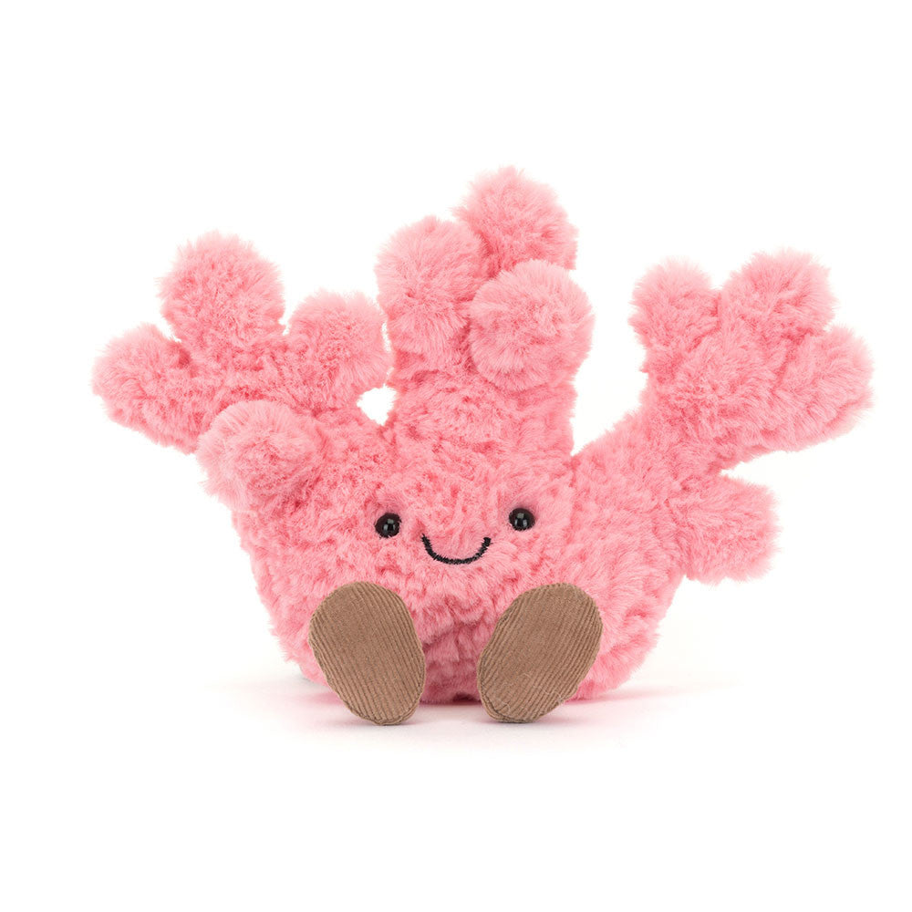 Pink plush coral toy with brown feet on a white background