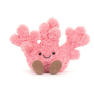 Pink plush coral toy with brown feet on a white background