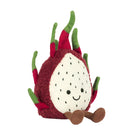 A plush toy resembling a dragon fruit with fuchsia fur and green fronds, smiling and sitting upright.