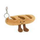 Plush sandal keychain with a smiling face on a white background