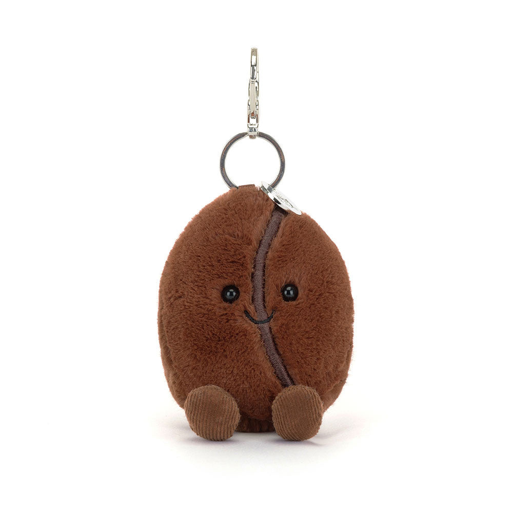 Plush keychain shaped like a coffee bean with a face on a white background