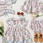 Children's floral dress with matching accessories on a white background