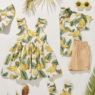 Children's clothing set with banana print dress, shorts, and accessories on a white background.
