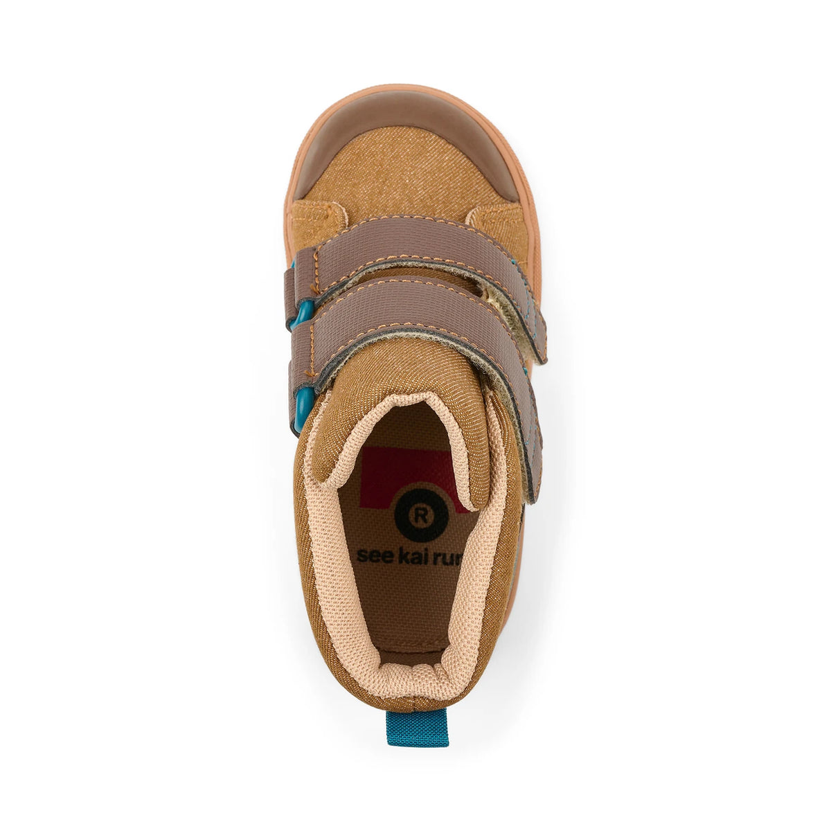 A top-down view of a toddler's high-top shoe in tan and brown, featuring two hook-and-loop straps with teal accents, a tan outsole, and a visible 'see kai run' logo on the insole.