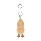 A  plush peanut-shaped keychain with a smiling face, textured beige body, brown feet.
