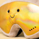 Close-up a shiny gold reflective lens, a smiling embroidered face on the lens.