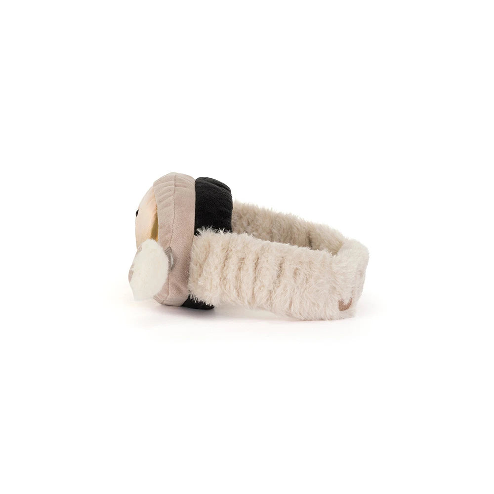 A plush baby headband with a soft beige knit exterior, fluffy cream inner lining, and a black accent band, shown from a side profile on a white background.