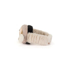 A plush baby headband with a soft beige knit exterior, fluffy cream inner lining, and a black accent band, shown from a side profile on a white background.