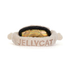 A plush pet headband featuring the brand name 'JELLYCAT' embroidered in beige on the front, with a black elastic band and a shiny gold interior lining, set against a plain white background.