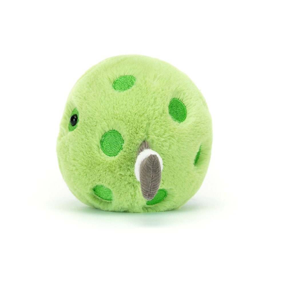Green plush toy with polka dots and brown arms on a white background