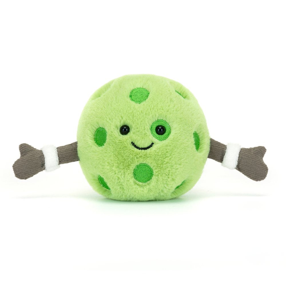Green plush toy with polka dots and brown arms on a white background