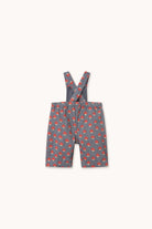 A pair of toddler boy's gray suspenders with a red and orange patterned fabric, displayed flat against a light cream background.
