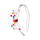 Clear headband with colorful polka dots on a white background