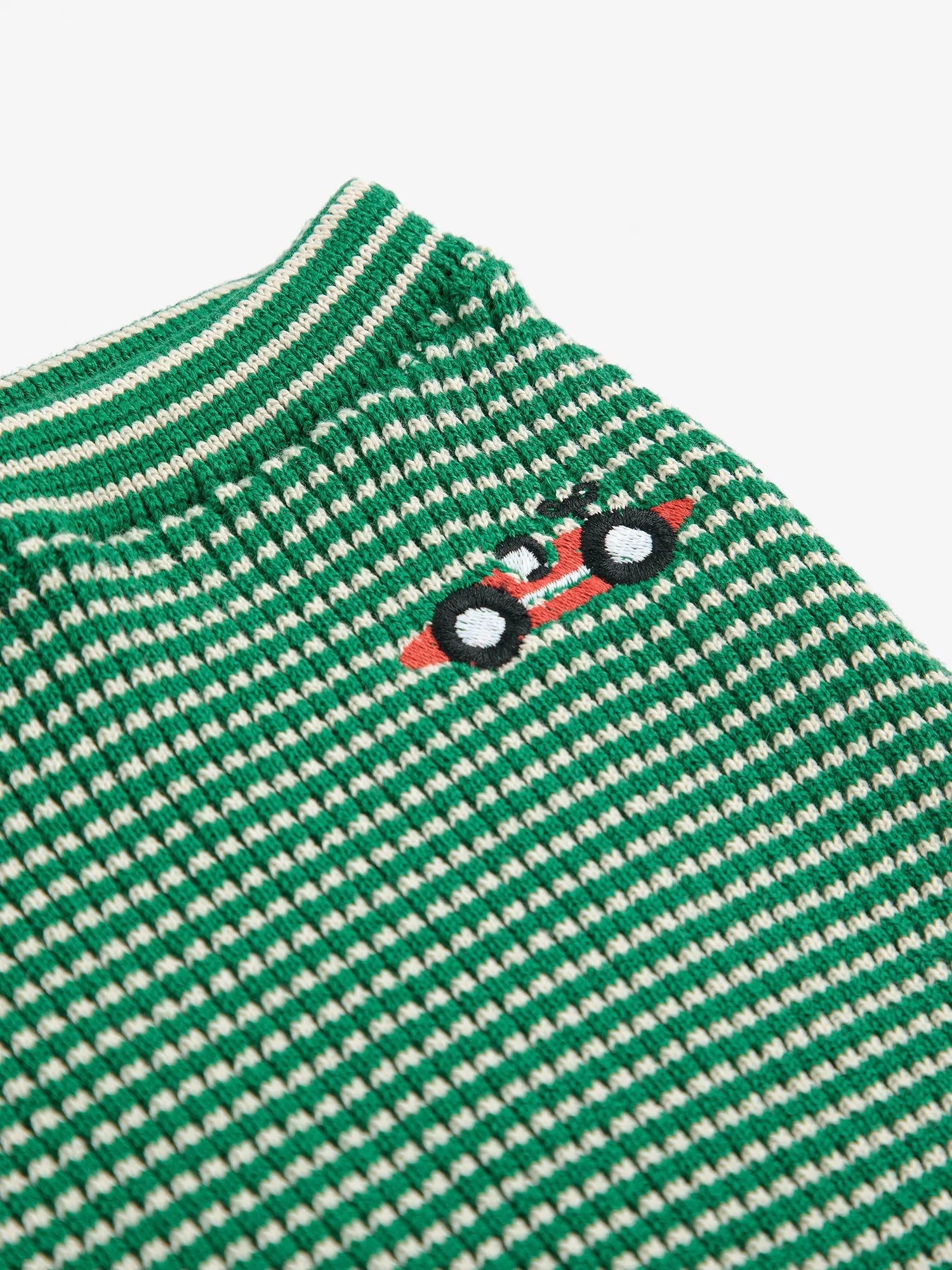Green and white striped shirt with a small logo on a white background