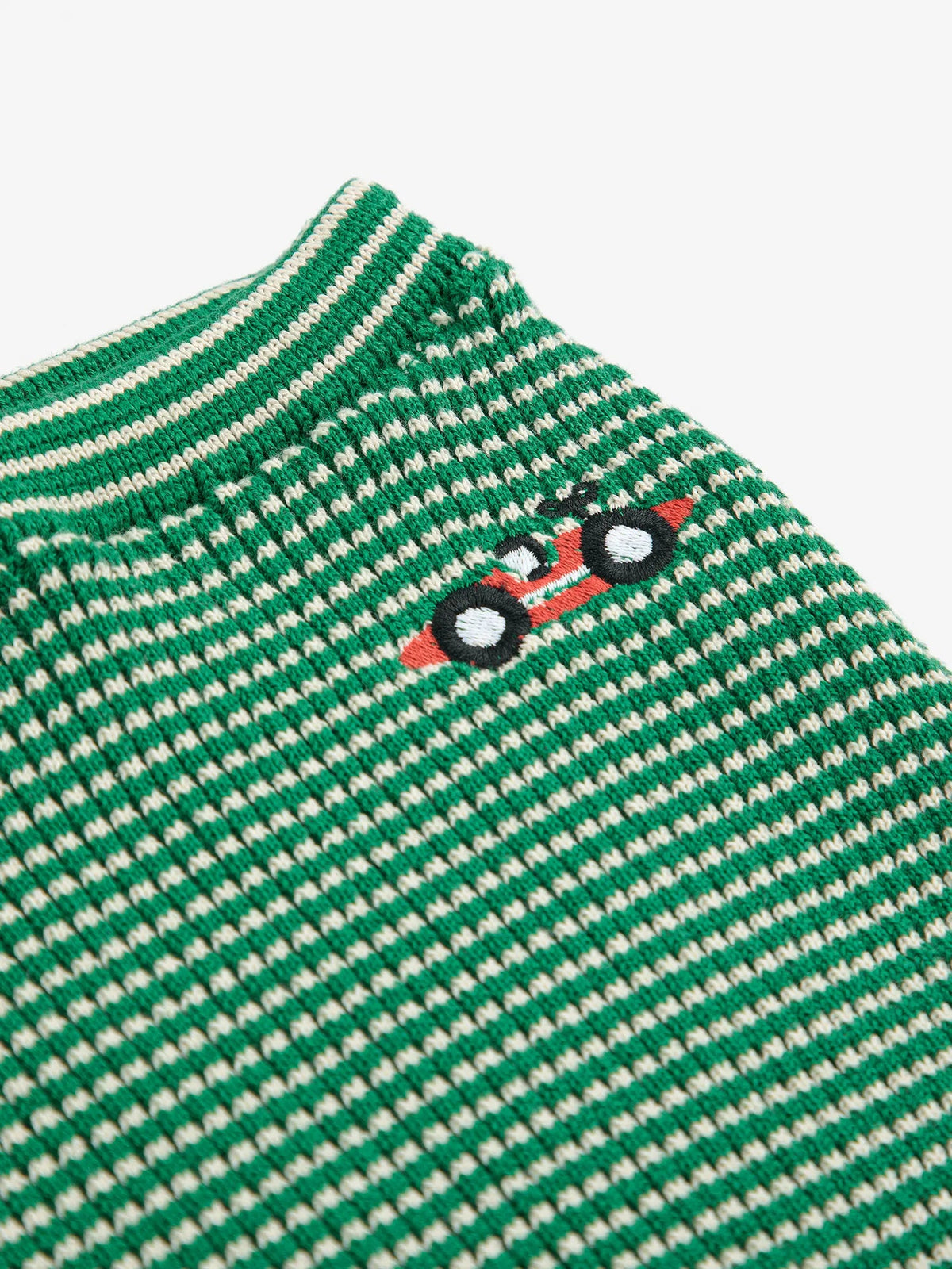 Green and white striped shirt with a small logo on a white background