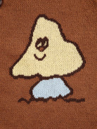Knitted design of a ghost on a brown background