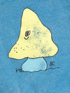 Yellow mushroom with a face on a blue background, signed 'BC'.