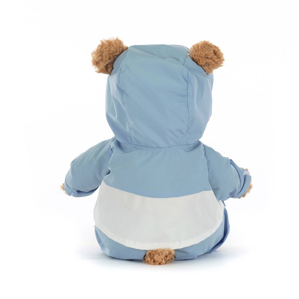 Stuffed animal toy with a blue and white outfit on a white background