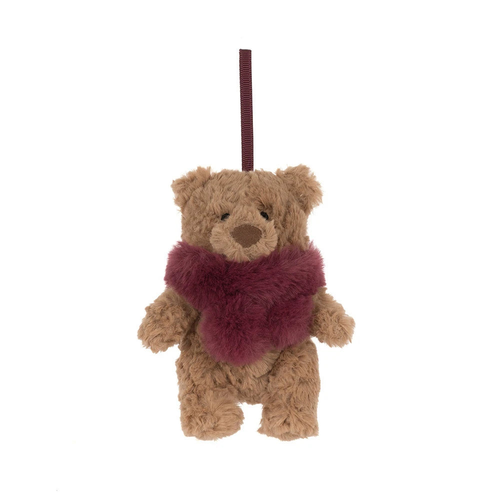 A small brown plush teddy bear ornament or hanging decoration with a fuzzy burgundy scarf and a dark red hanging loop at the top, shown on a plain white background.