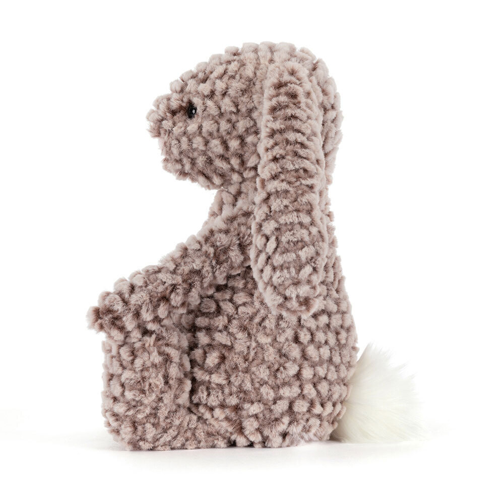 Plush toy dinosaur with textured fur on a white background