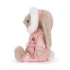 Plush toy rabbit in a pink outfit with white fur on a white background