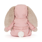 Plush toy dog in a pink outfit with fluffy ears on a white background