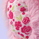 Close-up of a pink plush toy with floral patterned heart