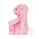 Pink plush bunny toy with floral pattern on a white background